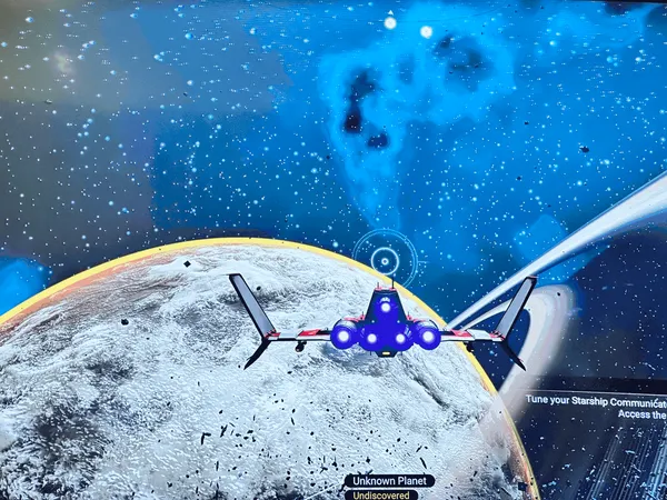 A red and white starship flying over an icy, undiscovered planet with a ringed planet and a blue nebula behind it